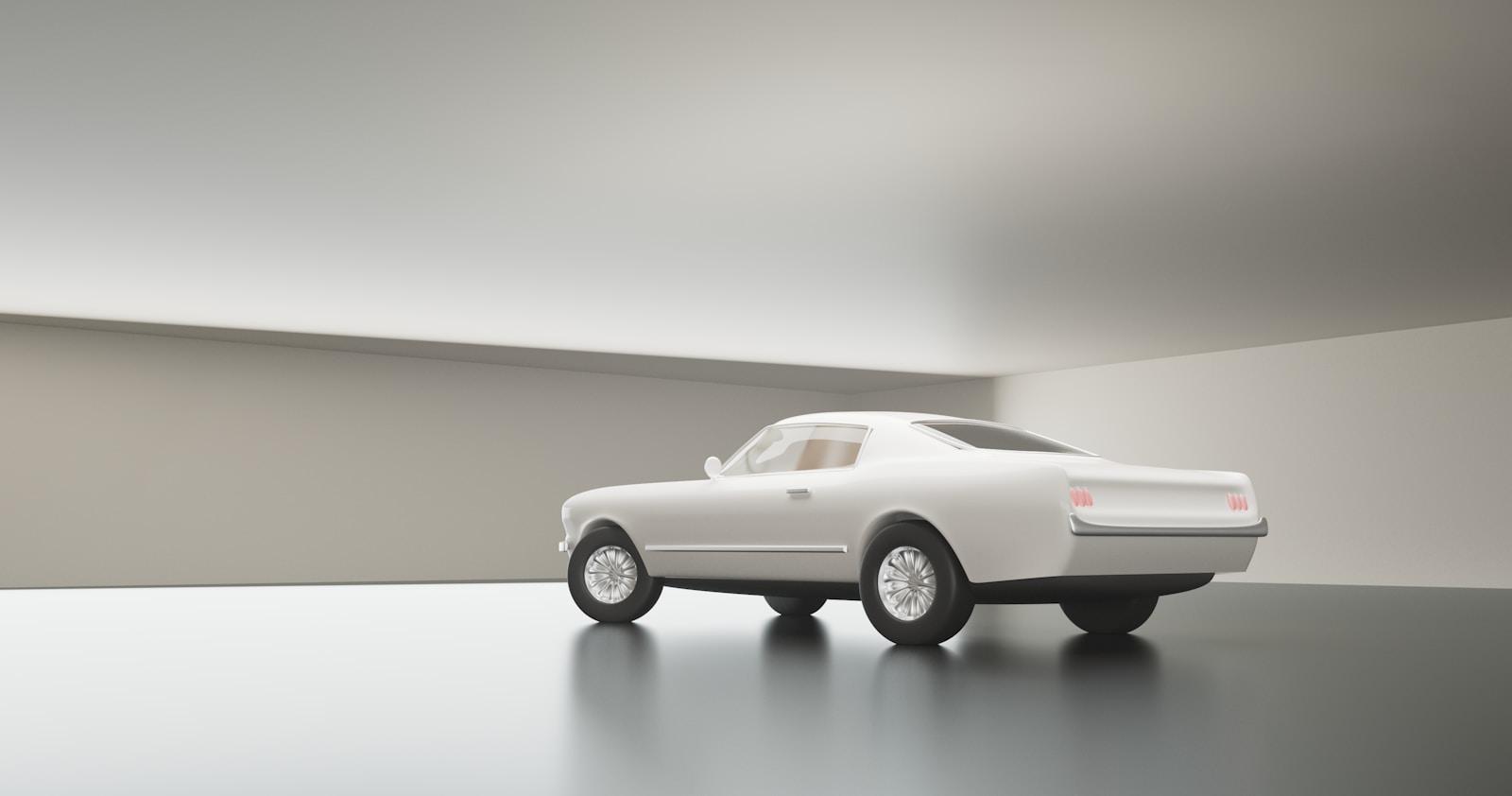 A white car driving down a road next to a white wall